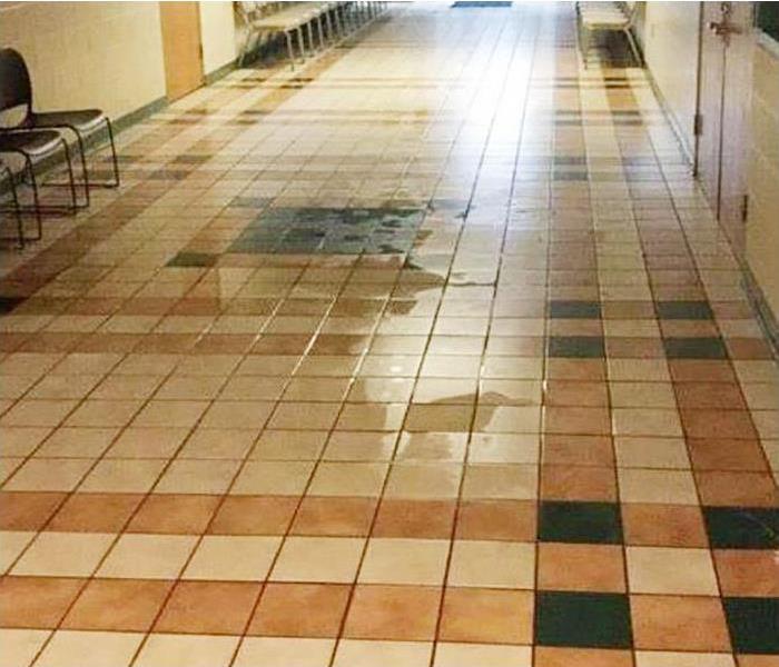 water covering tile floor in commercial property