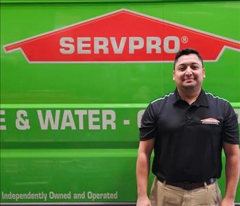 male posing in black shirt, by servpro van