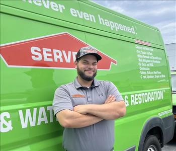 male, beard, arms akimbo, posing in front of van