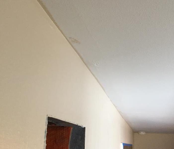water stains running along joint of the wall and ceiling in a room