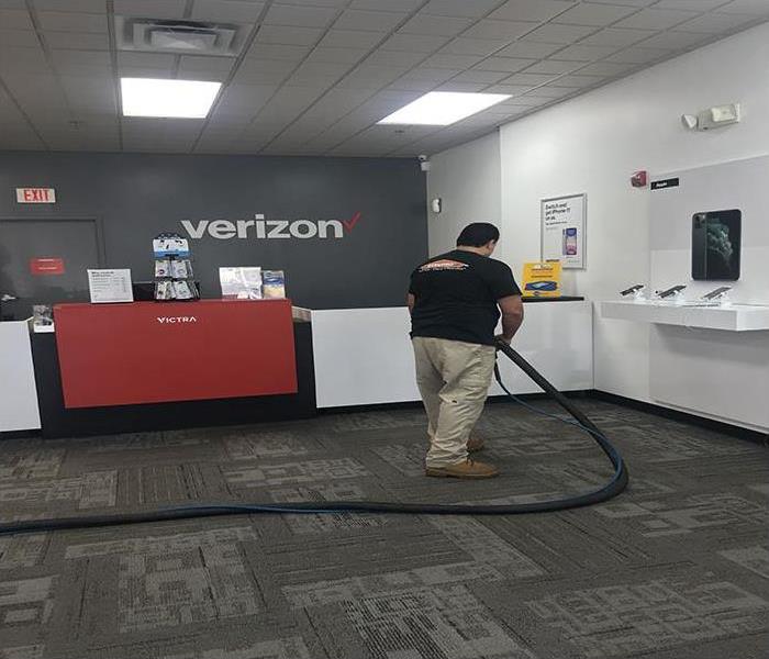 technician cleaning a commercial property after a storm