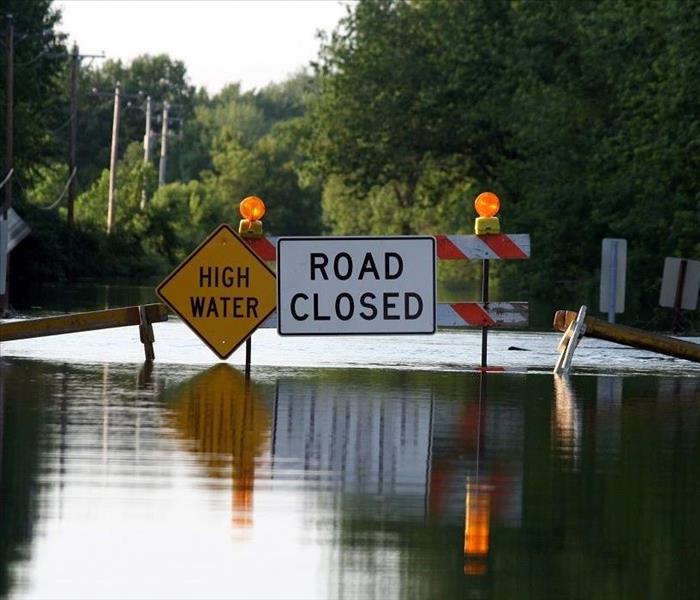 Flooded street; road closed and high-water signs
