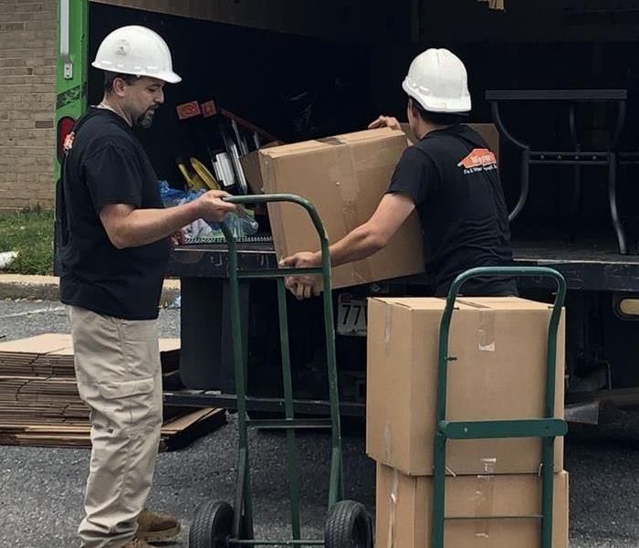 Two SERVPRO employees unloading a truck.